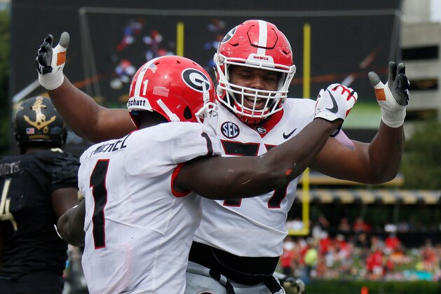 NASHVILLE, TN - OCTOBER 07:  Isaiah Wynn #77 of the Georgia Bulldogs congratulates teammate Sony Michel #1 on scoring a touchdown against the Vanderbilt Commodores during the second half at Vanderbilt Stadium on October 7, 2017 in Nashville, Tennessee.  (Photo by Frederick Breedon/Getty Images)