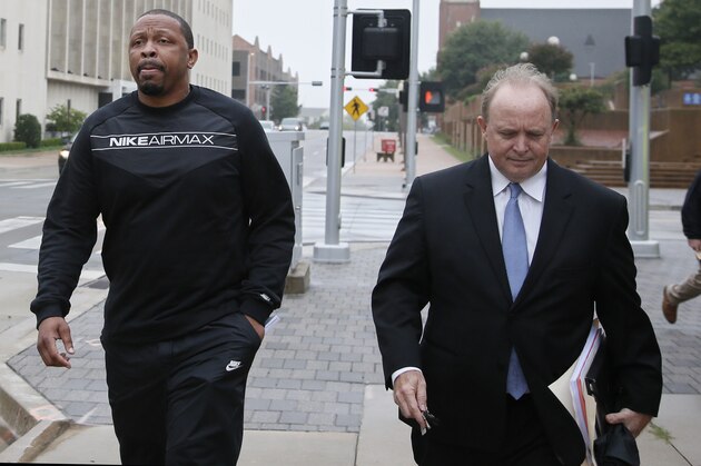 Lamont Evans, left, an assistant basketball coach at Oklahoma State University, and his attorney Trace Morgan leave the federal courthouse following a court appearance in Oklahoma City, Wednesday, Sept. 27, 2017. Evans is facing federal charges in conjunction with a wide probe of fraud and corruption in the NCAA. (AP Photo/Sue Ogrocki)