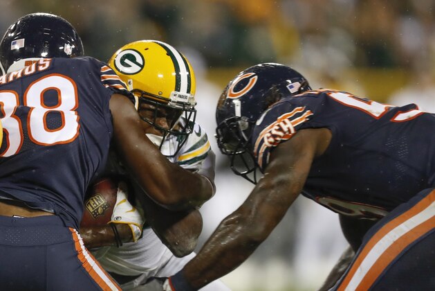 Green Bay Packers' Davante Adams is hit by Chicago Bears' Adrian Amos and Danny Trevathan during the second half of an NFL football game Thursday, Sept. 28, 2017, in Green Bay, Wis. The Bears were penalized on the play and Adams was taken off the field on a stretcher. (AP Photo/Matt Ludtke)