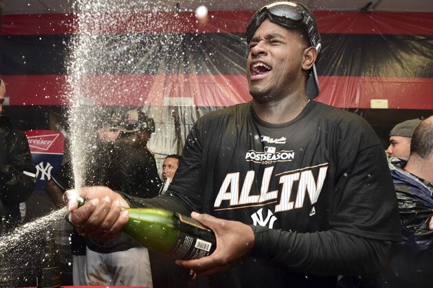 New York Yankees starting pitcher Luis Severino sprays sparkling wine in the locker room the Yankees defeated the Cleveland Indians 5-2 in Game 5 of a baseball American League Division Series, early Thursday, Oct. 12, 2017, in Cleveland. The Yankees advanced to the ALCS. (AP Photo/David Dermer)