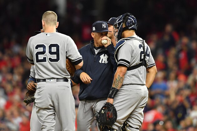 CLEVELAND, OH - OCTOBER 05: Manager Joe Girardi #28 speaks with Todd Frazier #29 and Gary Sanchez #24 of the New York Yankees after making a pitching change during the fourth inning against the Cleveland Indians during game one of the American League Division Series at Progressive Field on October 5, 2017 in Cleveland, Ohio.  (Photo by Jason Miller/Getty Images)