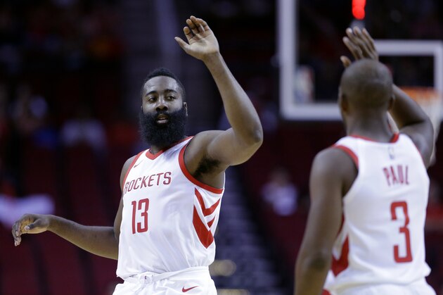 Houston Rockets guard James Harden (13) and Chris Paul (3 )high five in the first half of an NBA exhibition basketball game against the Shanghai Sharks Thursday, Oct. 5, 2017, in Houston. (AP Photo/Michael Wyke)