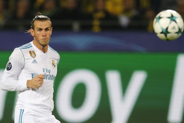 Real Madrid's Gareth Bale watches the ball go into the net as he scores his side's first goal during a Champions League Group H soccer match between Borussia Dortmund and Real Madrid at the BVB stadium in Dortmund, Germany, Tuesday, Sept. 26, 2017. (AP Photo/Michael Probst)
