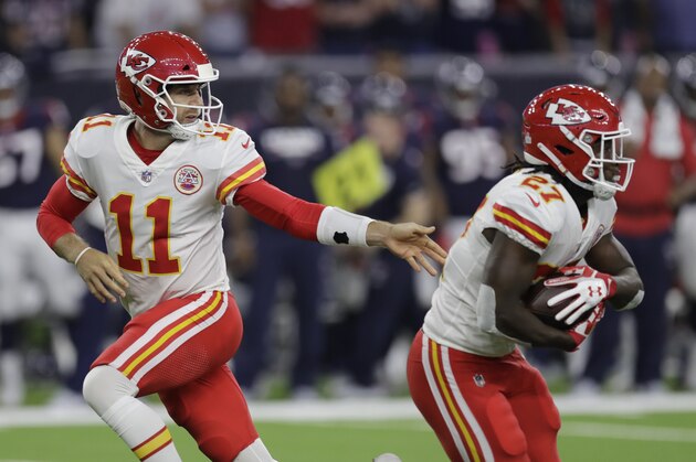 Kansas City Chiefs quarterback Alex Smith (11) hands the ball off to running back Kareem Hunt (27) during an NFL football game against the Houston Texans, Sunday, Oct. 8, 2017, in Houston. (AP Photo/David J. Phillip)