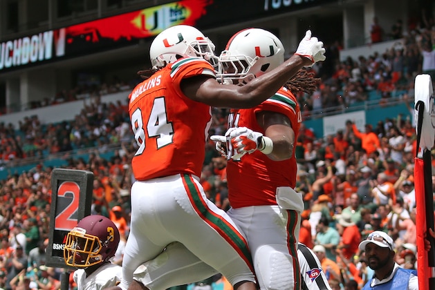 Miami Gardens, FL - SEPTEMBER 2: Darrell Langham #81 is congratulated by Dionte Mullins #84 of the Miami Hurricanes after scoring a touchdown against the Bethune Cookman Wildcats on September 2, 2017 at Hard Rock Stadium in Miami Gardens, Florida. Miami defeated Bethune-Cookman 41-13. (Photo by Joel Auerbach/Getty Images)