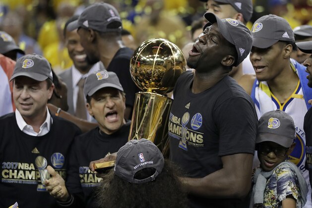 Golden State Warriors forward Draymond Green (23) holds the Larry O'Brien NBA Championship Trophy after Game 5 of basketball's NBA Finals against the Cleveland Cavaliers in Oakland, Calif., Monday, June 12, 2017. The Warriors won 129-120 to win the NBA championship. (AP Photo/Marcio Jose Sanchez)