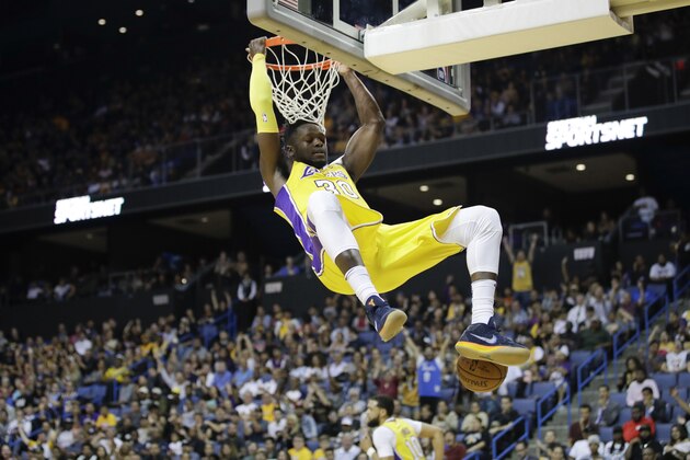 Los Angeles Lakers' Julius Randle descends after making a dunk during the second half of an NBA preseason basketball game against the Denver Nuggets, Wednesday, Oct. 4, 2017, in Ontario, Calif. (AP Photo/Jae C. Hong)