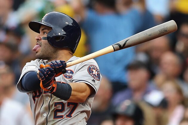BOSTON, MA - OCTOBER 08:  Jose Altuve #27 of the Houston Astros hits a single in the fifth inning against the Boston Red Sox during game three of the American League Division Series at Fenway Park on October 8, 2017 in Boston, Massachusetts.  (Photo by Elsa/Getty Images)