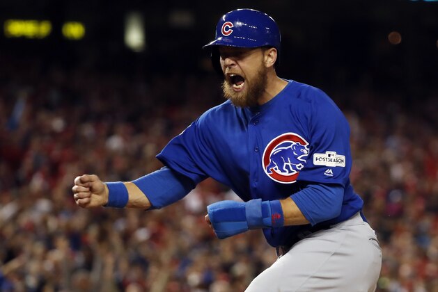 Chicago Cubs' Ben Zobrist reacts as he scores on a double by Addison Russell during the fifth inning of Game 5 of baseball's National League Division Series against the Washington Nationals, at Nationals Park, Thursday, Oct. 12, 2017, in Washington. Willson Contreras also scored on the play. (AP Photo/Alex Brandon)