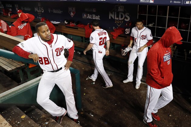Washington Nationals' players walk in the dugout after the Chicago Cubs beat the Nationals 9-8 to to win baseball's National League Division Series, at Nationals Park, early Friday, Oct. 13, 2017, in Washington. (AP Photo/Alex Brandon)