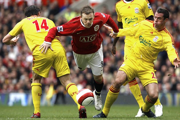 manchester, UNITED KINGDOM:  Manchester Unied's Wayne Rooney (C) fights for the ball against Liverpool's Xabi Alonso (L) and Jamie Carragher during their English Premiership soccer match at Old Trafford, Manchester, England, 22 October 2006. AFP PHOTO/ANDREW YATES   Mobile and website use of domestic English football pictures subject to subscription of a license with Football Association Premier League (FAPL) tel : +44 207 298 1656. For newspapers where the football content of the printed and electronic versions are identical, no licence is necessary.  (Photo credit should read ANDREW YATES/AFP/Getty Images)