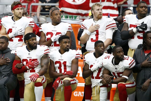 Members of the San Francisco 49ers kneel as others stand during the national anthem prior to an NFL football game against the Arizona Cardinals, Sunday, Oct. 1, 2017, in Glendale, Ariz. (AP Photo/Ross D. Franklin)
