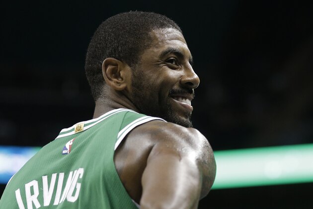 Boston Celtics' Kyrie Irving (11) smiles in the first half of a preseason NBA basketball game against the Charlotte Hornets in Charlotte, N.C., Wednesday, Oct. 11, 2017. (AP Photo/Chuck Burton)