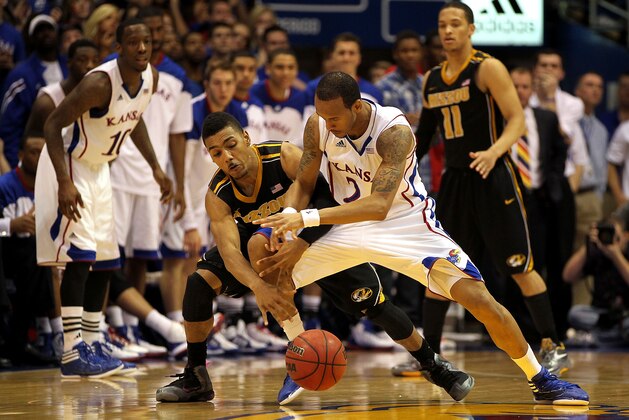 LAWRENCE, KS - FEBRUARY 25:  Travis Releford #24 of the Kansas Jayhawks and Phil Pressey #1 of the Missouri Tigers battle for a loose ball during the game on February 25, 2012 at Allen Fieldhouse in Lawrence, Kansas.  (Photo by Jamie Squire/Getty Images)