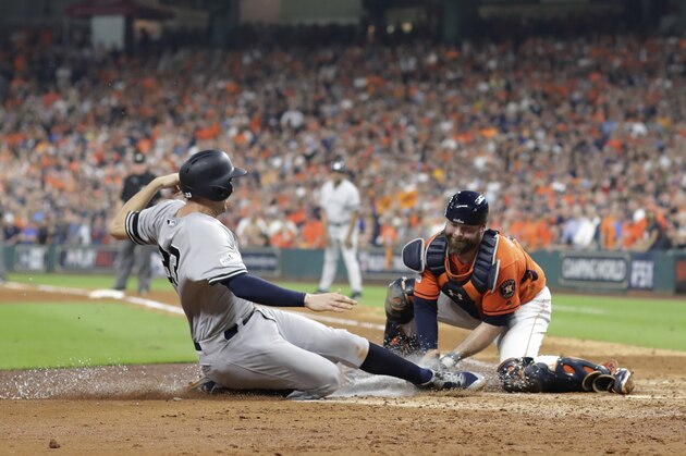 Houston Astros catcher Brian McCann tags out New York Yankees' Greg Bird at home during the fifth inning of Game 1 of baseball's American League Championship Series Friday, Oct. 13, 2017, in Houston. (AP Photo/David J. Phillip)