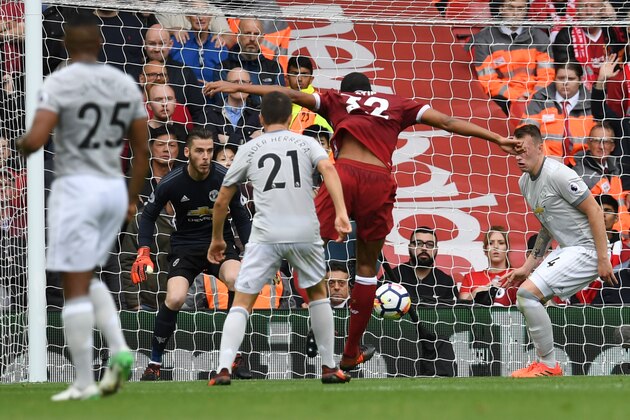 Liverpool's German-born Cameroonian defender Joel Matip (C) shoots from close range, forcing a save from Manchester United's Spanish goalkeeper David de Gea (2nd L) during the English Premier League football match between Liverpool and Manchester United at Anfield in Liverpool, north west England on October 14, 2017. / AFP PHOTO / Paul ELLIS / RESTRICTED TO EDITORIAL USE. No use with unauthorized audio, video, data, fixture lists, club/league logos or 'live' services. Online in-match use limited to 75 images, no video emulation. No use in betting, games or single club/league/player publications.  /         (Photo credit should read PAUL ELLIS/AFP/Getty Images)