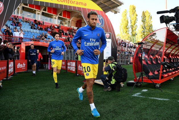 Paris Saint-Germain's Brazilian forward Neymar (C) and Paris Saint-Germain's French midfielder Adrien Rabiot (rear L) arrive on the football pitch prior to the French L1 football match between Dijon and Paris Saint-Germain at the Gaston Gerard stadium in Dijon, on October 14, 2017. / AFP PHOTO / FRANCK FIFE        (Photo credit should read FRANCK FIFE/AFP/Getty Images)