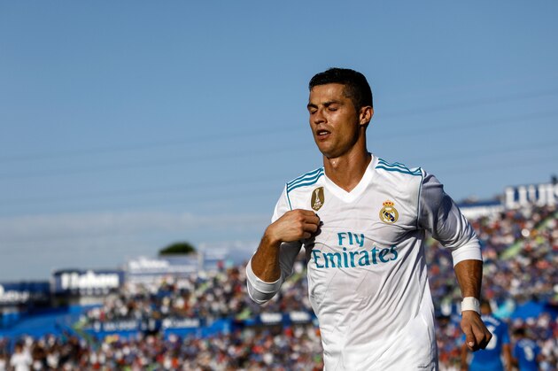 Real Madrid's Portuguese forward Cristiano Ronaldo crosses himself to celebrate his team's second goal during the Spanish league football match Getafe CF vs Real Madrid CF at the Col. Alfonso Perez stadium in Getafe on October 14, 2017. / AFP PHOTO / OSCAR DEL POZO        (Photo credit should read OSCAR DEL POZO/AFP/Getty Images)