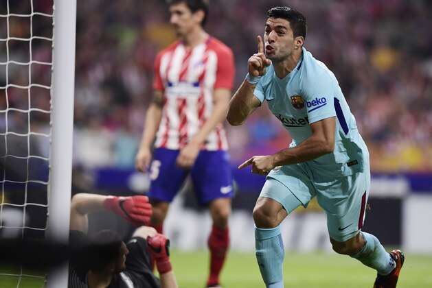 Barcelona's Uruguayan forward Luis Suarez celebrates a goal during the Spanish league football match Club Atletico de Madrid vs FC Barcelona at the Wanda Metropolitano stadium in Madrid on October 14, 2017. / AFP PHOTO / JAVIER SORIANO        (Photo credit should read JAVIER SORIANO/AFP/Getty Images)