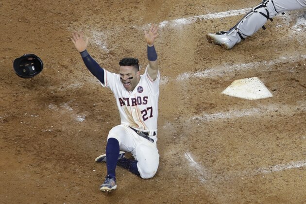Houston Astros' Jose Altuve scores the game-winning run past New York Yankees catcher Gary Sanchez during the ninth inning of Game 2 of baseball's American League Championship Series Saturday, Oct. 14, 2017, in Houston. The Astros won 2-1 to take a 2-0 lead in the series. (AP Photo/David J. Phillip)