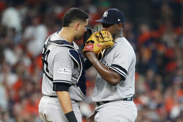 HOUSTON, TX - OCTOBER 14:  Luis Severino #40 and Gary Sanchez #24 of the New York Yankees meet on the mound as the homerun of Carlos Correa #1 of the Houston Astros is under review in the fourth inning during game two of the American League Championship Series at Minute Maid Park on October 14, 2017 in Houston, Texas.  (Photo by Elsa/Getty Images)