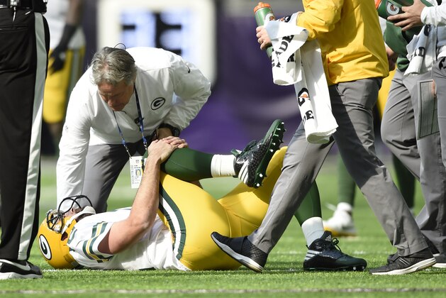 MINNEAPOLIS, MN - OCTOBER 15: Aaron Rodgers #12 of the Green Bay Packers clenches his right knee after being hit during the first quarter of the game against the Minnesota Vikings on October 15, 2017 at US Bank Stadium in Minneapolis, Minnesota. (Photo by Hannah Foslien/Getty Images)