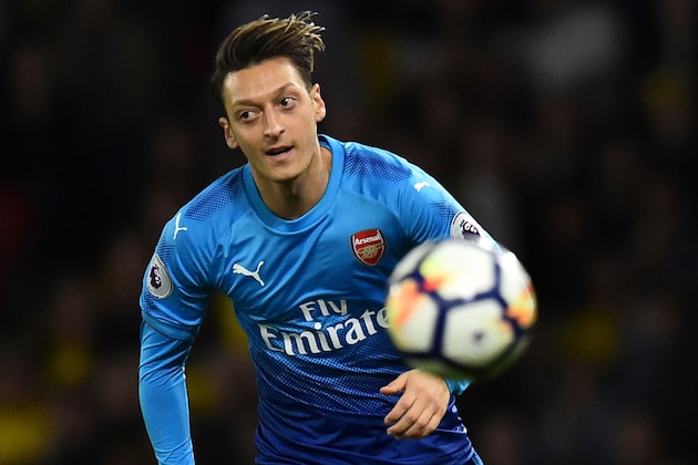 Arsenal's German midfielder Mesut Ozil chases the ball during the English Premier League football match between Watford and Arsenal at Vicarage Road Stadium in Watford, north of London on October 14, 2017. / AFP PHOTO / Glyn KIRK / RESTRICTED TO EDITORIAL USE. No use with unauthorized audio, video, data, fixture lists, club/league logos or 'live' services. Online in-match use limited to 75 images, no video emulation. No use in betting, games or single club/league/player publications.  /         (Photo credit should read GLYN KIRK/AFP/Getty Images)