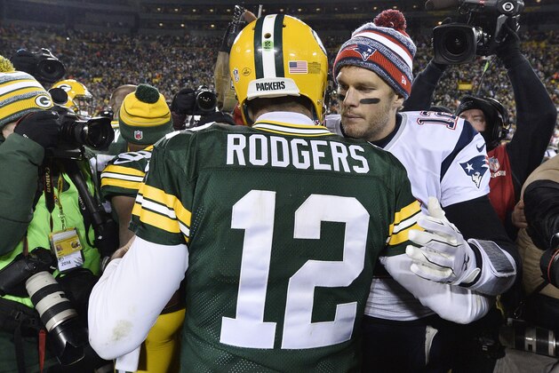 GREEN BAY, WI - NOVEMBER 30:  Tom Brady #12 of the New England Patriots (R) congratulates fellow quarterback Aaron Rodgers #12 of the Green Bay Packers after their game at Lambeau Field on November 30, 2014 in Green Bay, Wisconsin.  The Packers defeated the Patriots 26-21. (Photo by Brian D. Kersey/Getty Images)