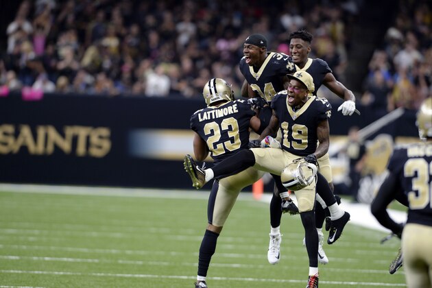 New Orleans Saints cornerback Marshon Lattimore (23) celebrates his interception and touchdown with wide receiver Ted Ginn (19) and defensive back Justin Hardee (34) in the second half of an NFL football game against the Detroit Lions in New Orleans, Sunday, Oct. 15, 2017. (AP Photo/Bill Feig)