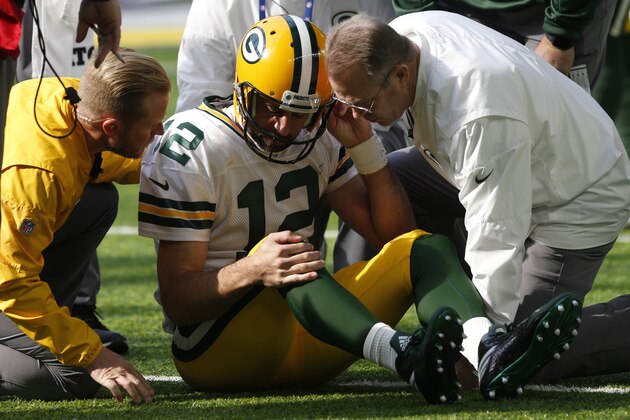 Green Bay Packers quarterback Aaron Rodgers gets up after being hit by Minnesota Vikings outside linebacker Anthony Barr (55) in the first half of an NFL football game in Minneapolis, Sunday, Oct. 15, 2017. (AP Photo/Jim Mone)