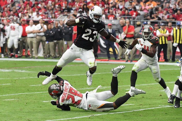GLENDALE, AZ - OCTOBER 15:  Adrian Peterson #23 of the Arizona Cardinals leaps over a tackle by Vernon Hargreaves III #28 of the Tampa Bay Buccaneers during the second quarter at University of Phoenix Stadium on October 15, 2017 in Glendale, Arizona.  (Photo by Norm Hall/Getty Images)