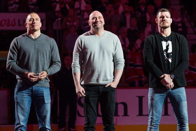 MONTREAL, QC - OCTOBER 14:  President of the UFC Dana White stands in-between Georges St-Pierre (L) and defending middleweight UFC champion Michael Bisping during the NHL game between the Montreal Canadiens and the Toronto Maple Leafs at the Bell Centre on October 14, 2017 in Montreal, Quebec, Canada.  (Photo by Minas Panagiotakis/Getty Images)