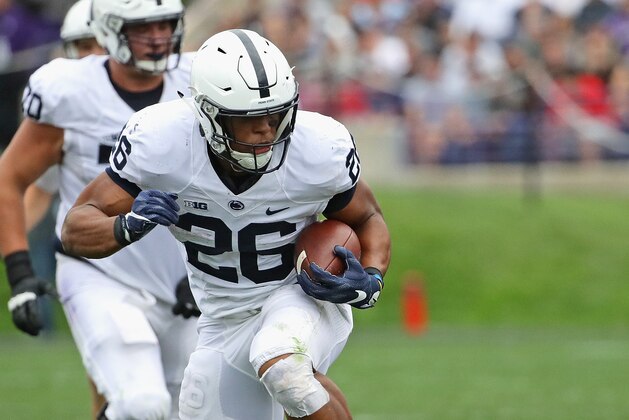 EVANSTON, IL - OCTOBER 07:  Saquon Barkley #26 of the Penn State Nittany Lions breaks a tackle attempt by Montre Hartage #24 of the Northwestern Wildcats on a 53 yard touchdown run at Ryan Field on October 7, 2017 in Evanston, Illinois. Penn State defeated Northwestern 31-7.  (Photo by Jonathan Daniel/Getty Images)