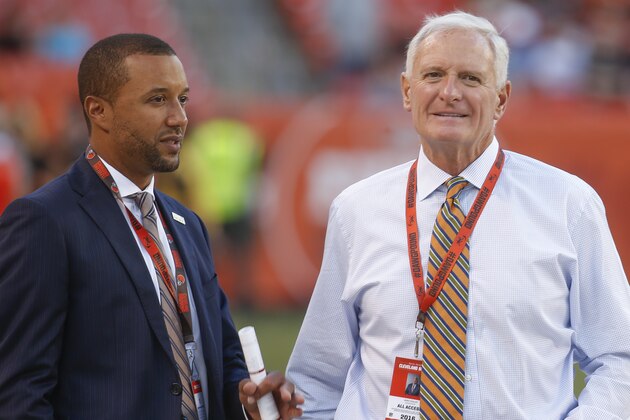 Sashi Brown, acting executive vice president of football operations for the Cleveland Browns, left, speaks with Browns' owner Jimmy Haslam on the field during practice before an NFL preseason football game against the Atlanta Falcons, Thursday, Aug. 18, 2016, in Cleveland. (AP Photo/Ron Schwane)
