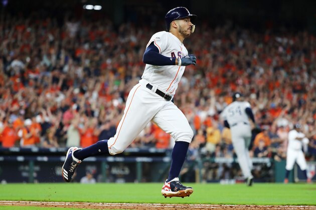 HOUSTON, TX - OCTOBER 14:  Carlos Correa #1 of the Houston Astros runs to first on his double in the ninth inning scoring Jose Altuve #27 of the Houston Astros to defeat the New York Yankees 2 to 1 in game two of the American League Championship Series at Minute Maid Park on October 14, 2017 in Houston, Texas.  (Photo by Elsa/Getty Images)
