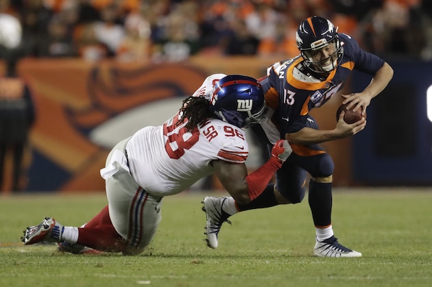 New York Giants defensive tackle Damon Harrison (98) hauls down Denver Broncos quarterback Trevor Siemian for a sack during the second half of an NFL football game Sunday, Oct. 15, 2017, in Denver. (AP Photo/Joe Mahoney)