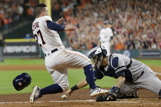 Houston Astros' Jose Altuve scores the game-winning run past New York Yankees catcher Gary Sanchez during the ninth inning of Game 2 of baseball's American League Championship Series Saturday, Oct. 14, 2017, in Houston. The Astros won 2-1 to take a 2-0 lead in the series. (AP Photo/Tony Gutierrez)
