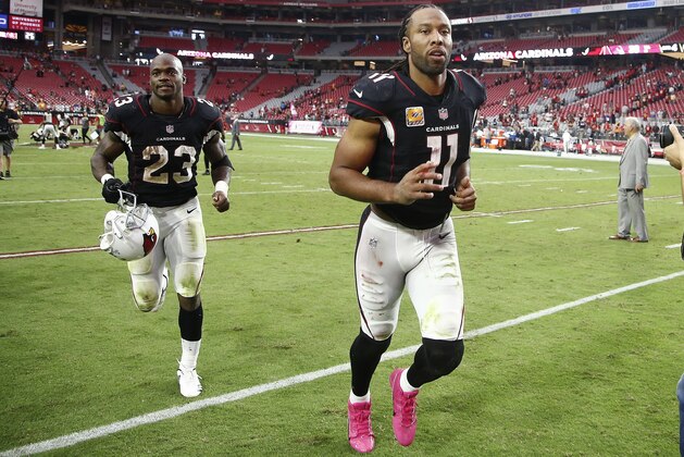 Arizona Cardinals running back Adrian Peterson (23) and wide receiver Larry Fitzgerald (11) run off the field after an NFL football game against the Tampa Bay Buccaneers Sunday, Oct. 15, 2017, in Glendale, Ariz. The Cardinals defeated the Buccaneers 38-33. (AP Photo/Ralph Freso)
