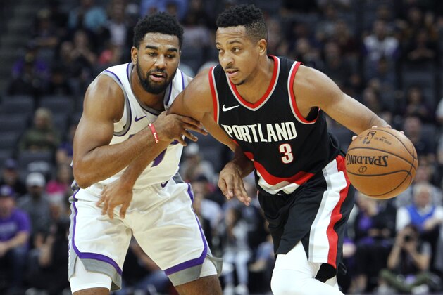 FILE - In this Oct. 9, 2017, file photo, Portland Trail Blazers guard CJ McCollum, right, is fouled by Sacramento Kings defender Matt Jones during the first half of an NBA preseason basketball game in Sacramento, Calif. Portland didn't make a lot of changes in the offseason as the team remains anchored by the backcourt duo of Damian Lillard and McColllum. (AP Photo/Steve Yeater, File)
