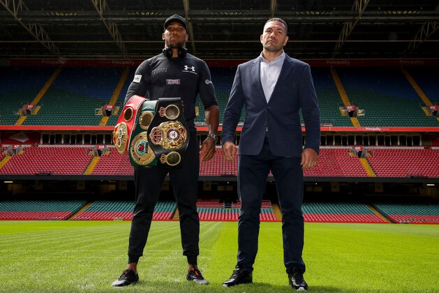 Britain's Anthony Joshua (L) and Bulgaria's Kubrat Pulev (R) stand on the pitch at the Principality Stadium in Cardiff on September 11, 2017 during a promotional event for their heavyweight world title boxing match. 
Britain's Anthony Joshua will defend his IBO, IBF and WBA world heavyweight titles against Bulgaria's Kubrat Pulev at Cardiff's Principality Stadium on October 28.
 / AFP PHOTO / Geoff CADDICK        (Photo credit should read GEOFF CADDICK/AFP/Getty Images)