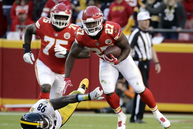 Kansas City Chiefs running back Kareem Hunt (27) runs past a tackle attempt by Pittsburgh Steelers linebacker Vince Williams (98) during the second half of an NFL football game in Kansas City, Mo., Sunday, Oct. 15, 2017. (AP Photo/Charlie Riedel)