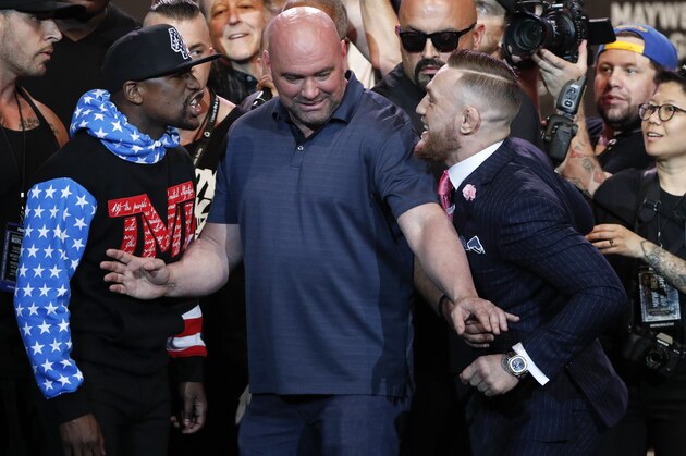 UFC president Dana White, center, intervenes as Floyd Mayweather Jr., left, and Conor McGregor exchange words during a news conference at Staples Center Tuesday, July 11, 2017, in Los Angeles. The two will fight in a boxing match in Las Vegas on Aug. 26. (AP Photo/Jae C. Hong)