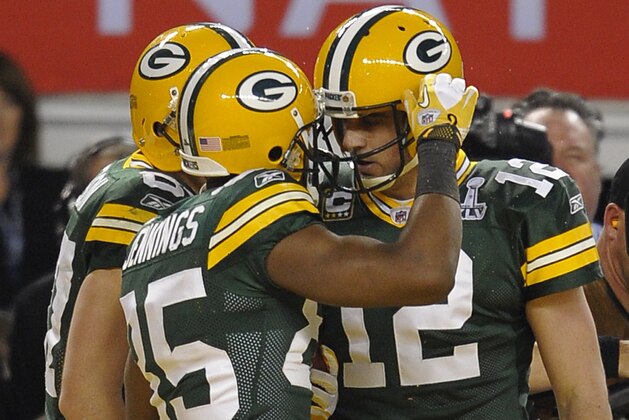 Greg Jennings (L) of the Green Bay Packers is congratulated by quarterback Aaron Rodgers after scoring a touchdown during the NFL Super Bowl XLV football game on February  6, 2011 at Cowboys Stadium in Arlington, Texas.   AFP PHOTO / TIMOTHY A. CLARY (Photo credit should read TIMOTHY A. CLARY/AFP/Getty Images)