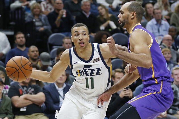 Utah Jazz guard Dante Exum (11) drives around Sydney Kings forward Perry Ellis, right, during the second half of a preseason NBA basketball game Monday, Oct. 2, 2017, in Salt Lake City. (AP Photo/Rick Bowmer)