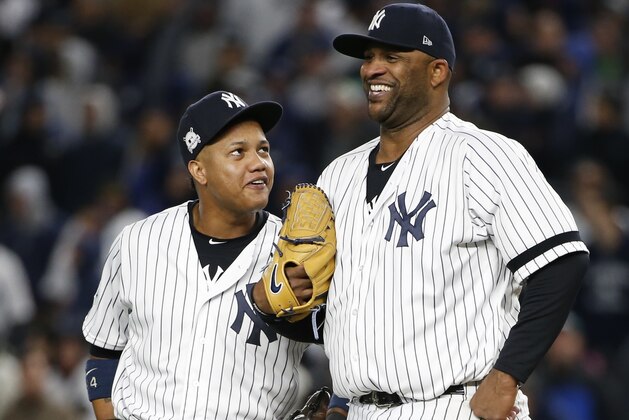 New York Yankees' Starlin Castro talks to CC Sabathia during the sixth inning of Game 3 of baseball's American League Championship Series against the Houston Astros Monday, Oct. 16, 2017, in New York. (AP Photo/Kathy Willens)
