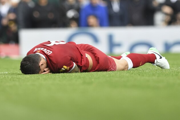 Liverpool's Croatian defender Dejan Lovren lies injured after a tangle with  Manchester United's Belgian striker Romelu Lukaku during the English Premier League football match between Liverpool and Manchester United at Anfield in Liverpool, north west England on October 14, 2017. / AFP PHOTO / Paul ELLIS / RESTRICTED TO EDITORIAL USE. No use with unauthorized audio, video, data, fixture lists, club/league logos or 'live' services. Online in-match use limited to 75 images, no video emulation. No use in betting, games or single club/league/player publications.  /         (Photo credit should read PAUL ELLIS/AFP/Getty Images)