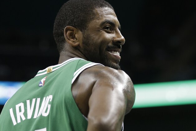 Boston Celtics' Kyrie Irving (11) smiles in the first half of a preseason NBA basketball game against the Charlotte Hornets in Charlotte, N.C., Wednesday, Oct. 11, 2017. (AP Photo/Chuck Burton)