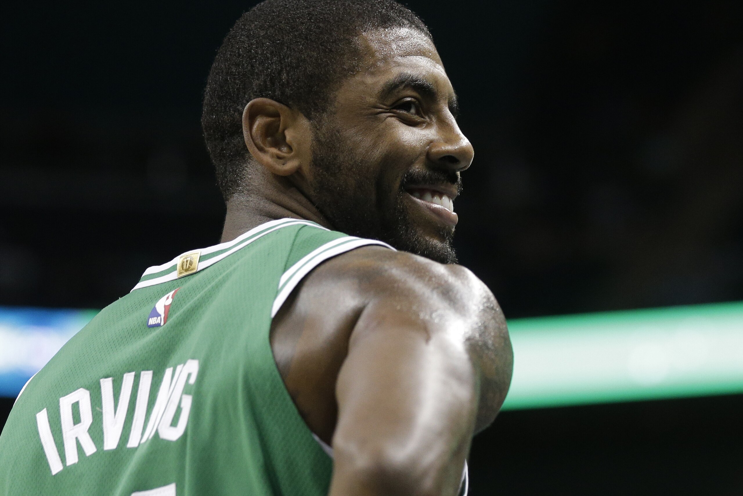 Boston Celtics' Kyrie Irving (11) smiles in the first half of a preseason NBA basketball game against the Charlotte Hornets in Charlotte, N.C., Wednesday, Oct. 11, 2017. (AP Photo/Chuck Burton)