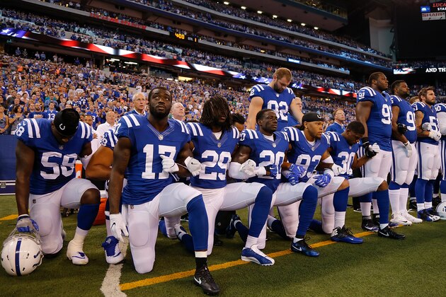 INDIANAPOLIS, IN - SEPTEMBER 24:  Members of the Indianapolis Colts stand and kneel for the national anthem prior to the start of the game between the Indianapolis Colts and the Cleveland Browns at Lucas Oil Stadium on September 24, 2017 in Indianapolis, Indiana.  (Photo by Michael Reaves/Getty Images)