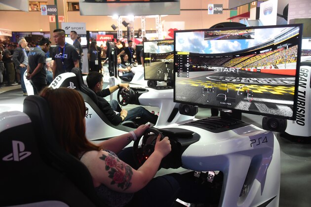 Gaming fans play Gran Turismo on PS4 during the 2016 Electronic Entertainment Expo (E3) annual video game conference and show at the Los Angeles Convention Center on June 14, 2016 in Los Angeles, California. / AFP / FREDERIC J. BROWN        (Photo credit should read FREDERIC J. BROWN/AFP/Getty Images)